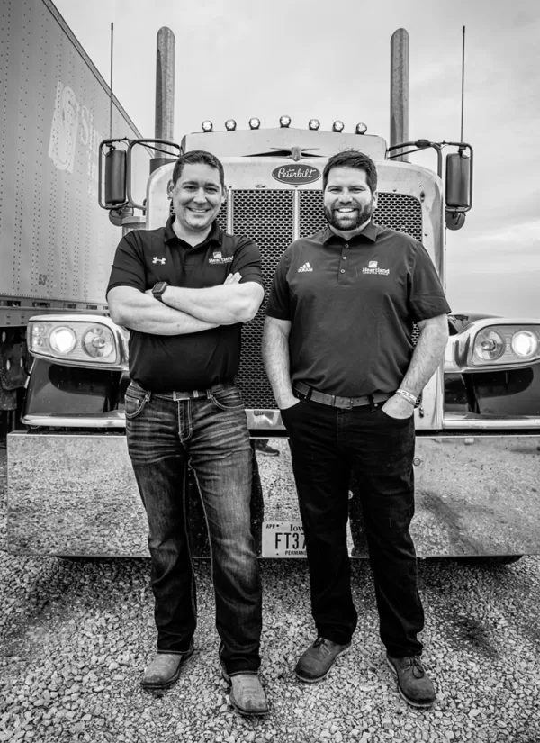 John and Scott standing in front of a semi truck